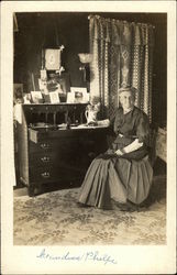 Esther A. Phelps at her desk Postcard