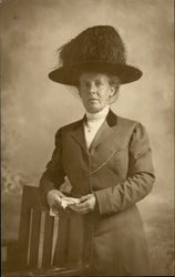 Woman in Large Hat Posing by a Chair Postcard