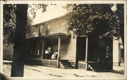 Family on Porch of Residence Postcard