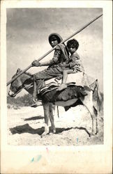 Two Children Riding a Donkey Postcard