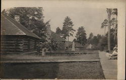 Row of Log Cabins Postcard