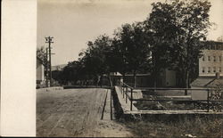 View Down Road in Town Buildings Postcard Postcard Postcard