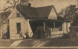 Snapshot of Family Outside Residence Postcard