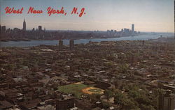 Aerial View of Town and Manhattan Skyline Postcard