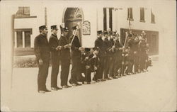 Row of Men in Uniform Holding Axes - Firemen? Postcard