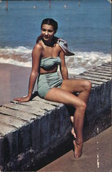 Woman In Blue Swimsuit Sitting On Beach Wall Postcard