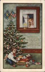 Boy playing with toys under Christmas tree Postcard