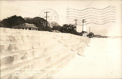 Sea Wall, White Sand Beach and Lighthouse Postcard