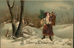 A Merry Christmas - Santa carrying a tree through the snow Santa Claus Postcard Postcard Postcard