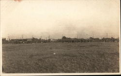 Soldiers Marching Outside of Town Postcard