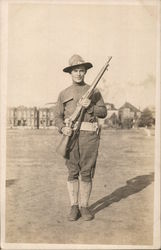 Soldier with Rifle Posing in Camp Postcard