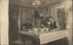 Two men eating a meal at a kitchen table Postcard Postcard Postcard