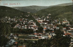 View of town nestled between hills Postcard