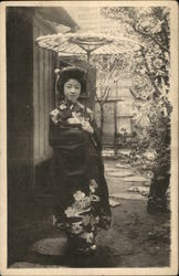 A young Japanese woman wearing typical dress Postcard