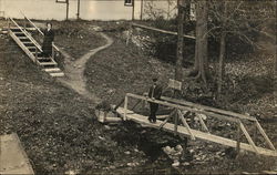 Couple Crossing Creek Bridge Postcard