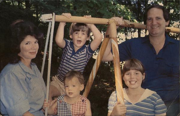 the-smith-family-posing-with-swing-set-tuftonboro-nh-postcard