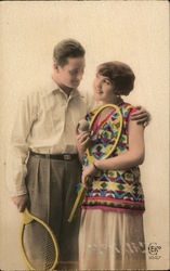 Man and Woman Holding Tennis Rackets Standing Close Together Postcard