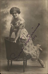 Young Woman in Dress Kneeling on Chair Postcard