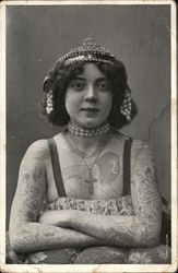 A Woman Wearing a Tiara Covered in Tattoos Postcard