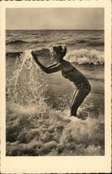 A Woman in a Bikini Plays in the Ocean Swimsuits & Pinup Postcard Postcard Postcard