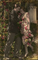 A man giving a woman flowers Postcard Postcard Postcard