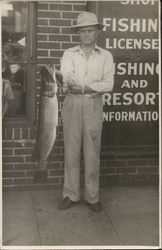 Man Holding 14-lb. Northern Pike Near Building Park Rapids, MN Postcard Postcard Postcard