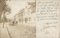 Man with Mule-Drawn Cart on Cobblestone Street Near Houses Postcard