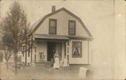 Mother and Three Young Children in Front of House Postcard