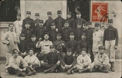 Uniformed Men Posing for Four-Tier Group Photo Postcard