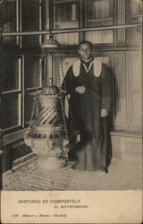 Man Dressed in Religious Garb Near Large Metal Artifact Postcard