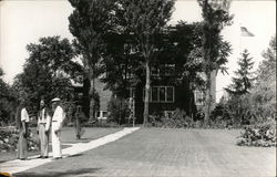 Three People Standing in a Yard Postcard