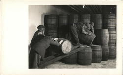 Men rolling barrel up ramp to be stacked. Benton Harbor, MI House of David Postcard Postcard Postcard