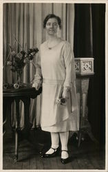 A Woman Standing Next to a Table House of David Postcard Postcard Postcard