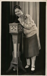 Dark-Haired Woman Leaning Over Podium Benton Harbor, MI House of David Postcard Postcard Postcard