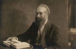 Man with Round Glasses and Beard Reading a Book Postcard