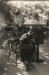 White-Haired Woman in Rocking Chair Reading Book Postcard