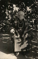 White-Haired Woman Wearing Plaid Shawl Seated Outdoors Postcard