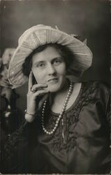 A Woman Wearing a Hat and Pearls Postcard