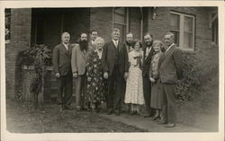 Group of 10, Standing in Front of Brick Structure Outdoors Postcard