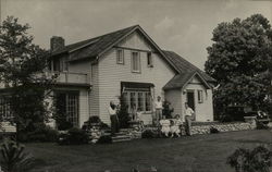 Wide View of People in Front of House Postcard