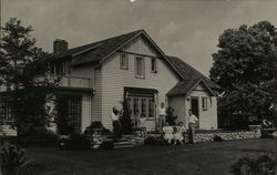 Group of People and a Dog In Front of House Postcard