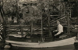 Man Sitting in Boat with "Eden Springs" Pennant Postcard