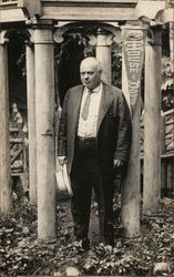 Man in Suit Holding Hat Near "House of David" Pennant Postcard