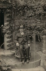 Man in Chair Outdoors Postcard