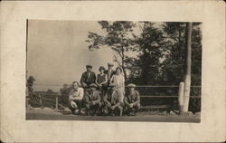 A Group of Eight Standing Next to a Fence Postcard