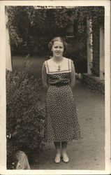 A Woman Posing Next to a Bush House of David Postcard Postcard Postcard