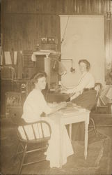 Two Women in Office Setting with Switchboard Postcard