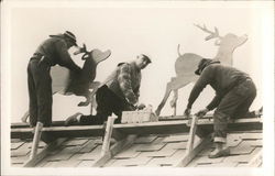 Workers on Roof Setting up Reindeer Decorations Postcard