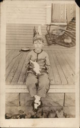 Boy with Feathered Headband Seated on Porch Holding Bird Children Postcard Postcard Postcard