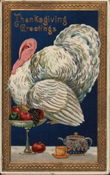 A turkey, fruit and tea set on a tabletop. Postcard